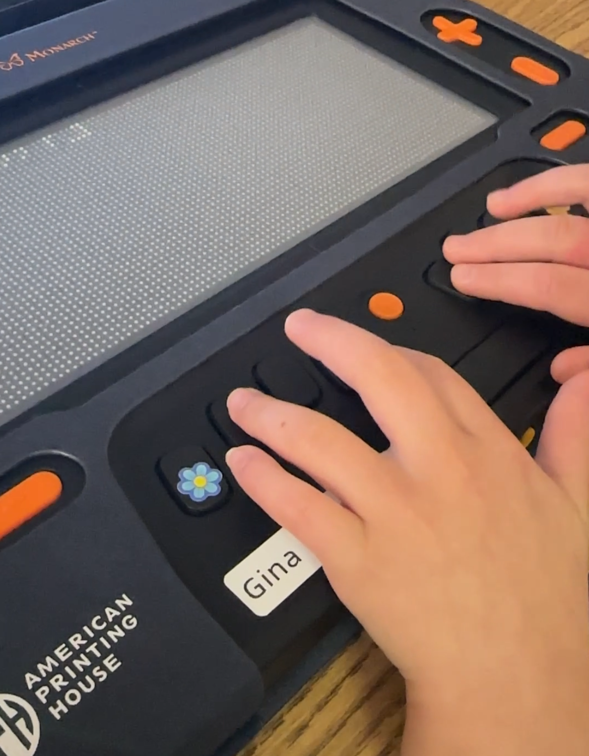 Young student's hands placed on the Monarch keypad and it appears they are about to type the letter j. 